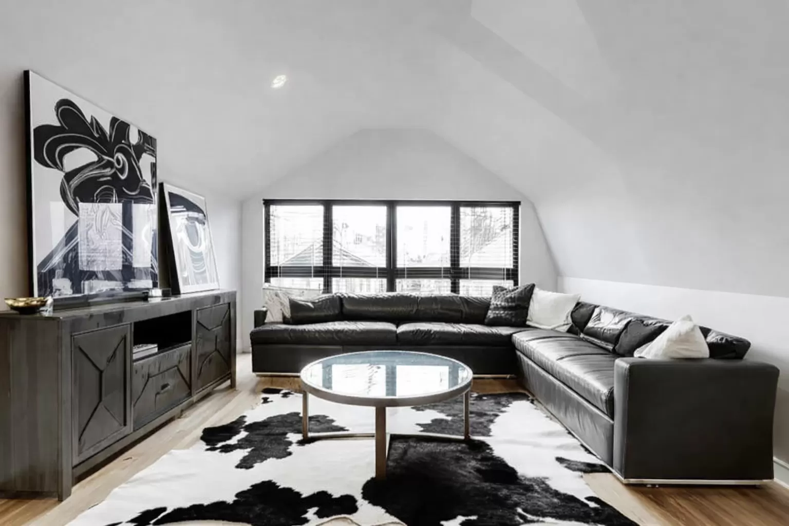 Black and white cowhide rug displayed in a refined living room