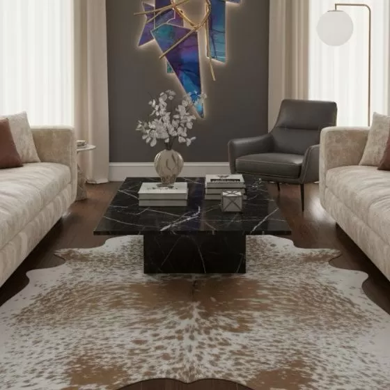 Salt and pepper cowhide rug styled in a refined living room